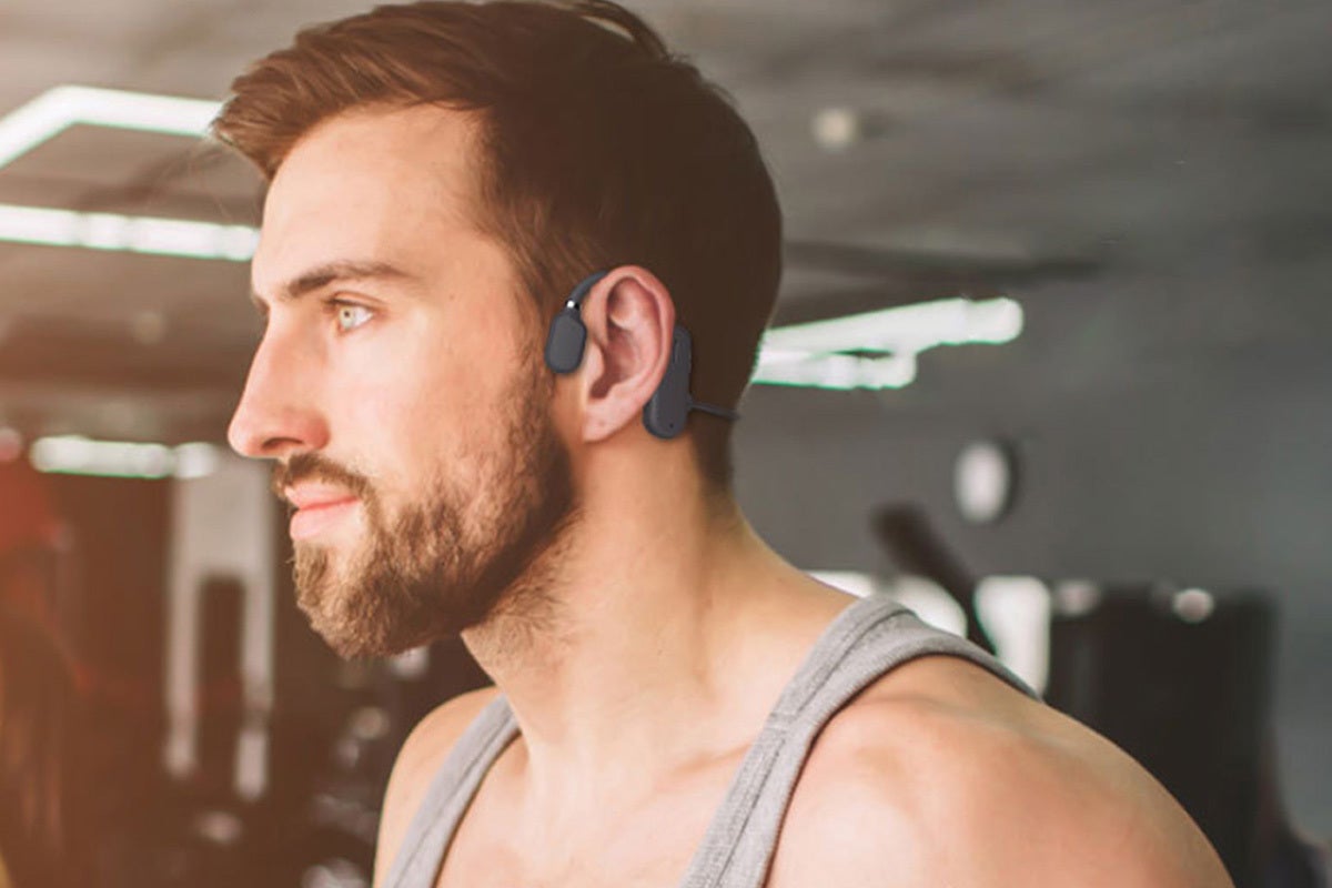 A person working out wearing a pair of bone conduction headphones