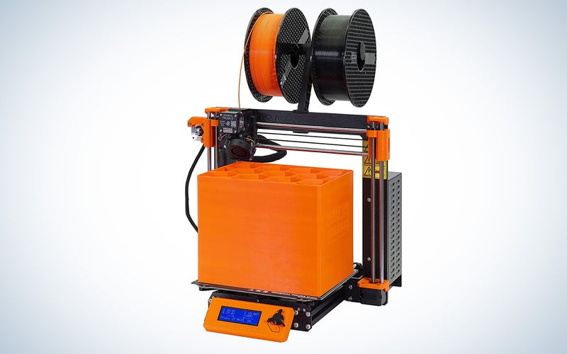 The best 3D printer for beginners Prusa model with a large orange structure on the print bed.