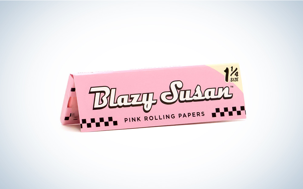 A booklet of pink Blazy Susan rolling papers on a blue and white background