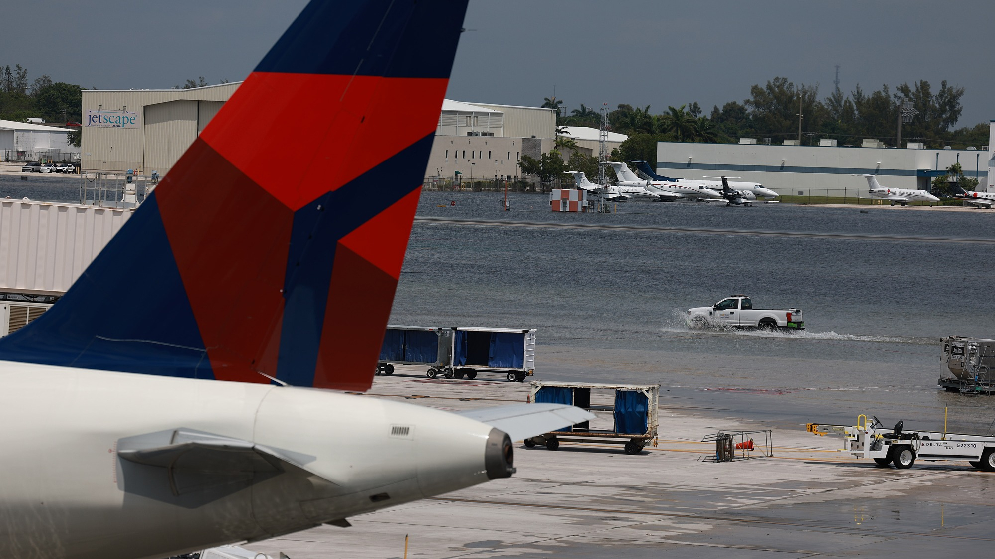Planes sit at their gates after the Fort Lauderdale-Hollywood International Airport was closed due to the runways being flooded on April 13, 2023 in Fort Lauderdale, Florida. The heavy rain caused flooding as the region recorded rainfall totals of more than a foot.