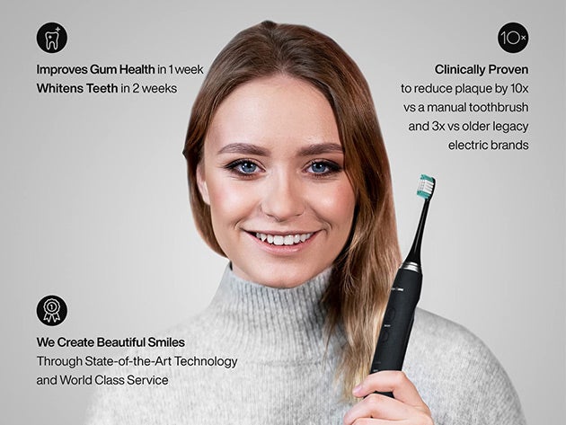 A woman holding a toothbrush and smiling