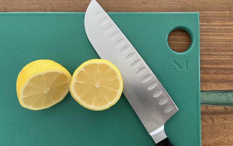 Material Cutting Board with lemon and knife on top