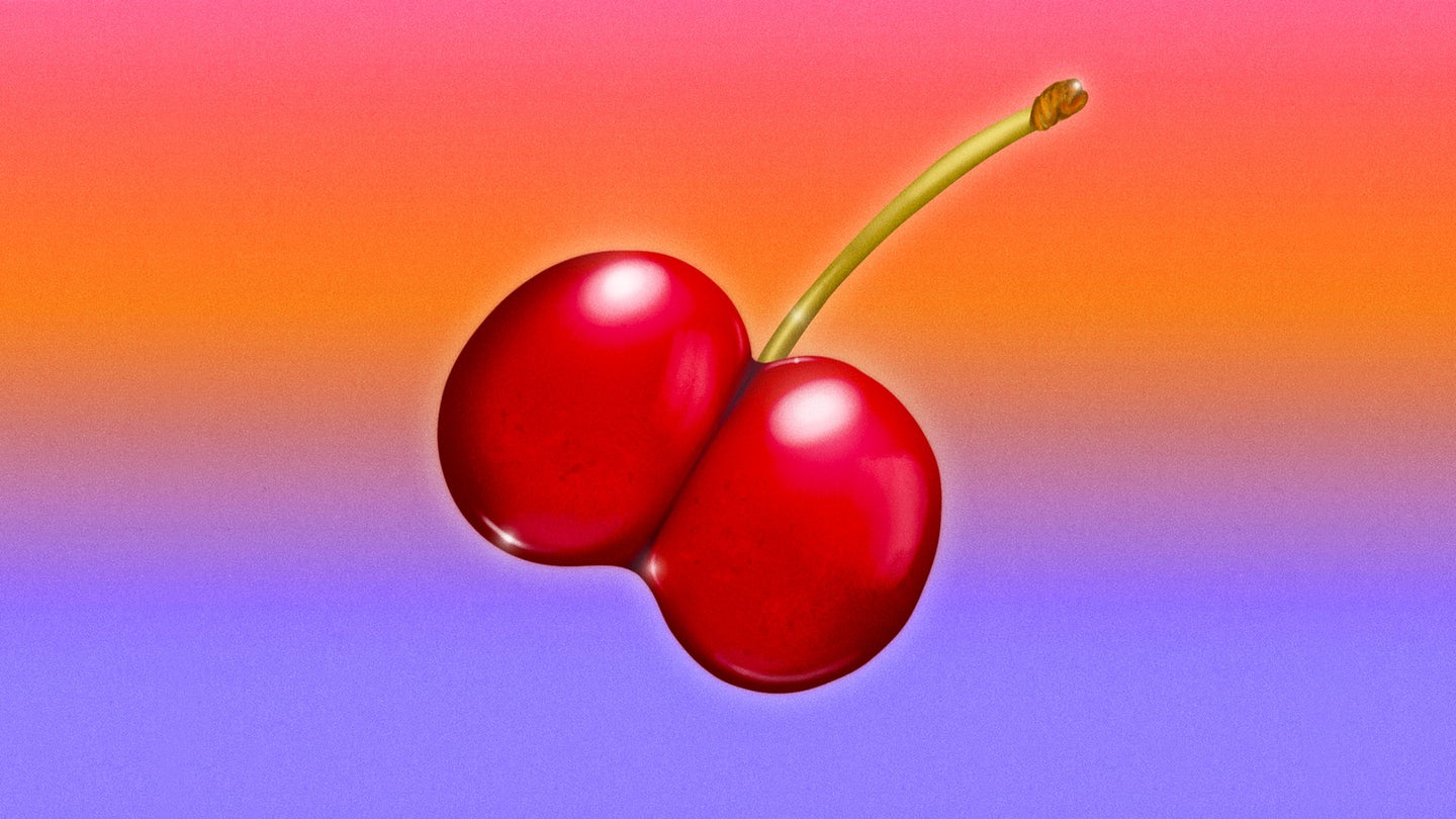 Red cherry shaped as butt on orange and purple ombre background