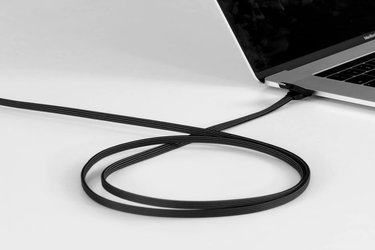 A black cable plugged into a laptop