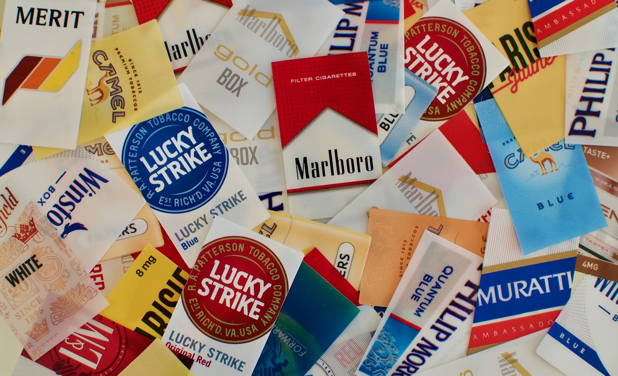 Discarded cigarette labels like Marlboro and Lucky Strike to depict declining smoking rates in the US