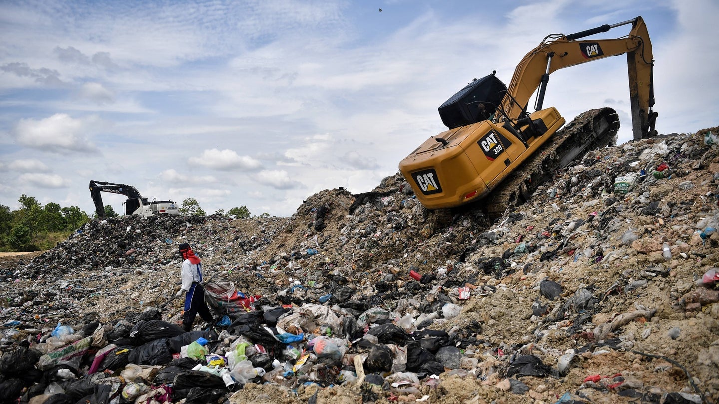 This photo taken on June 5, 2020 shows a garbage collector looking for recyclable plastic at the Ban Tarn landfill site in the northern Thai province of Chiang Mai.