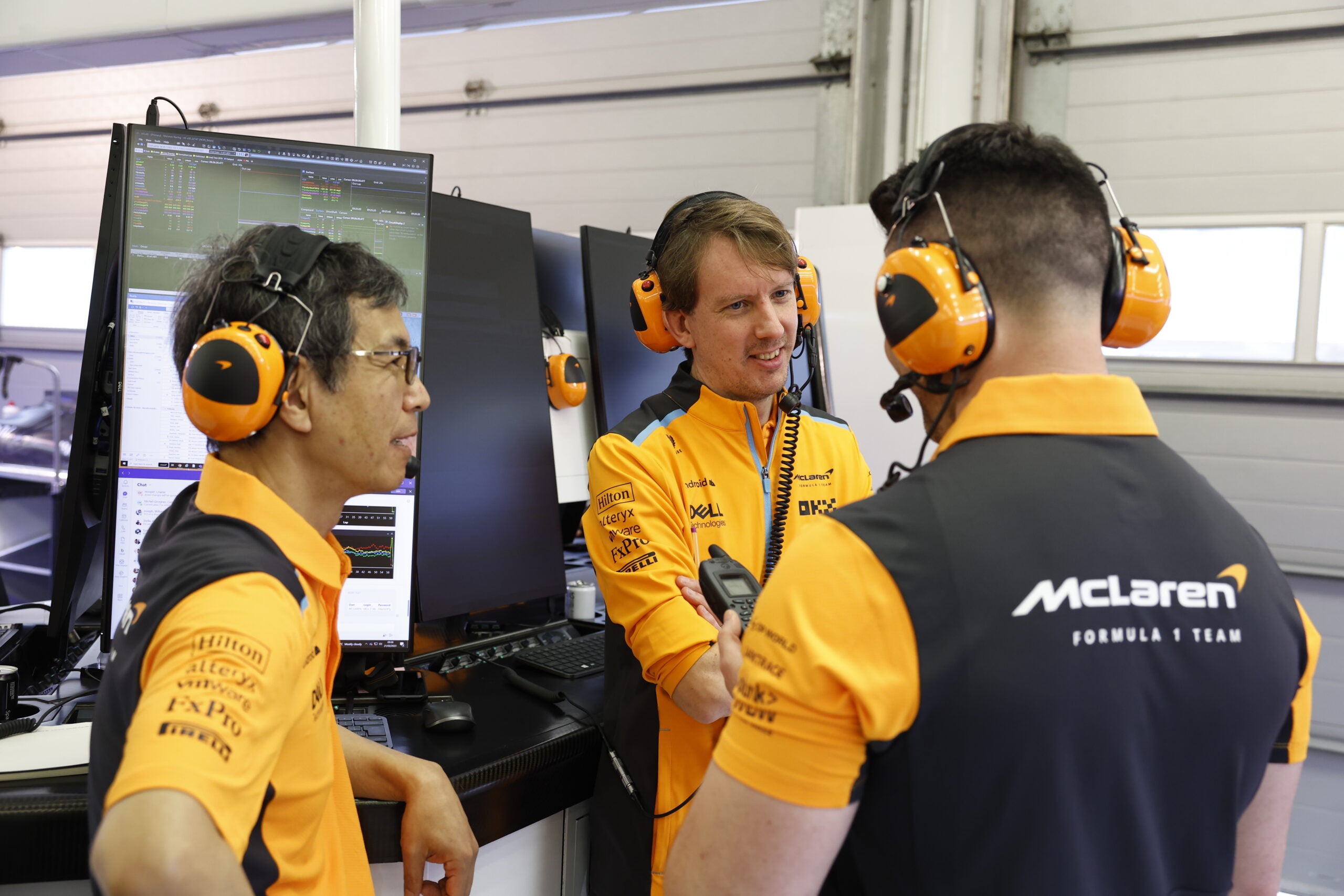 McLaren engineers speak in the garage
