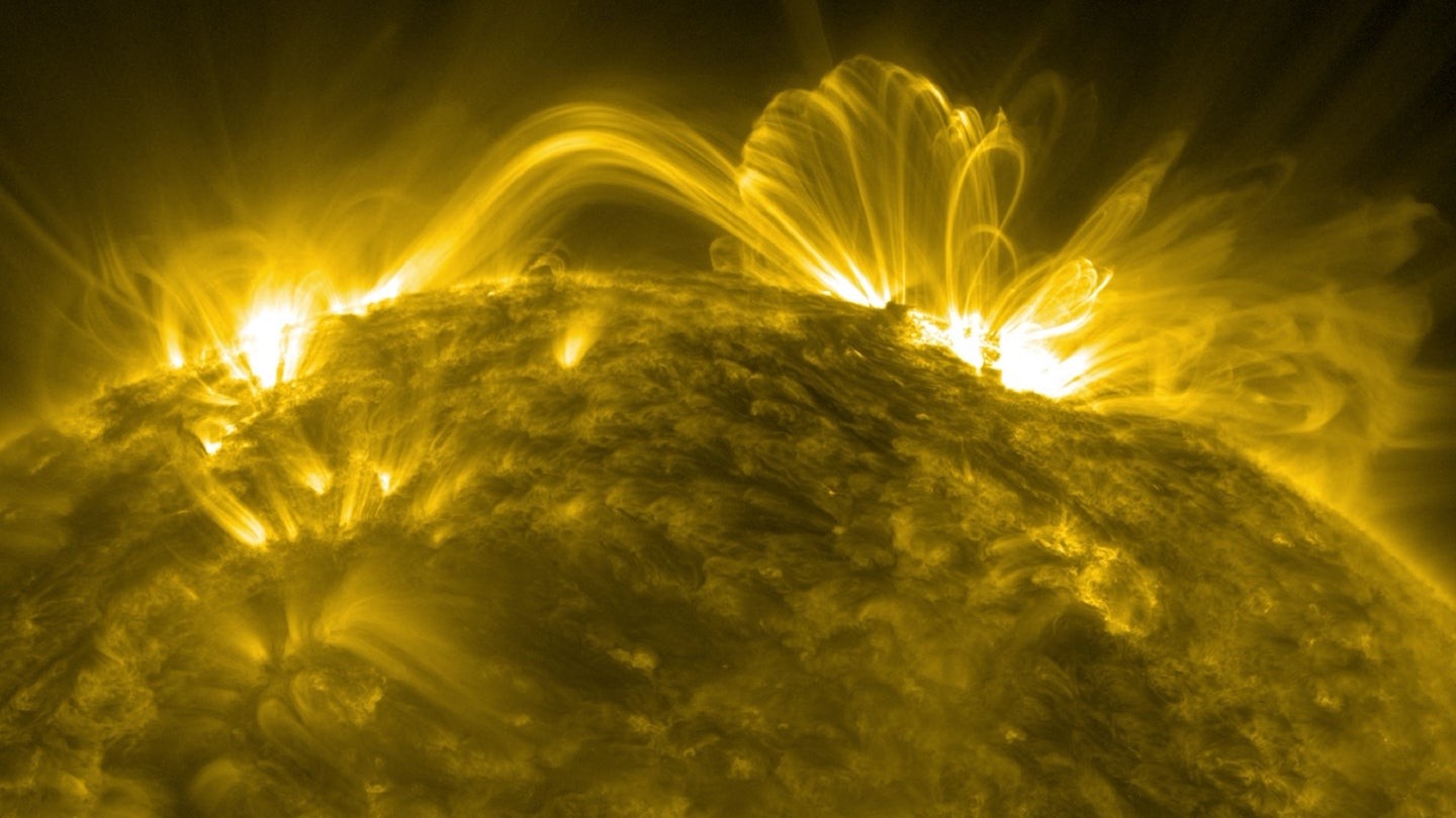 Magnetic arches and solar flares emerging from the upper half of the sun's corona