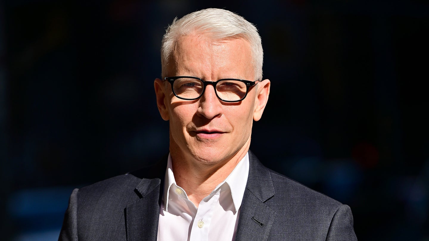 Anderson Cooper wearing suit and glasses