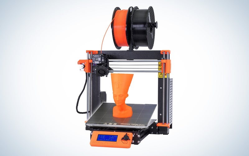 Prusa i3 3D printer with an orange statue head on the print bed