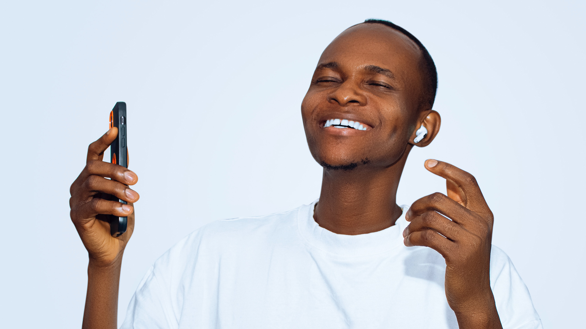 Seemingly happy person listening to music on earbuds