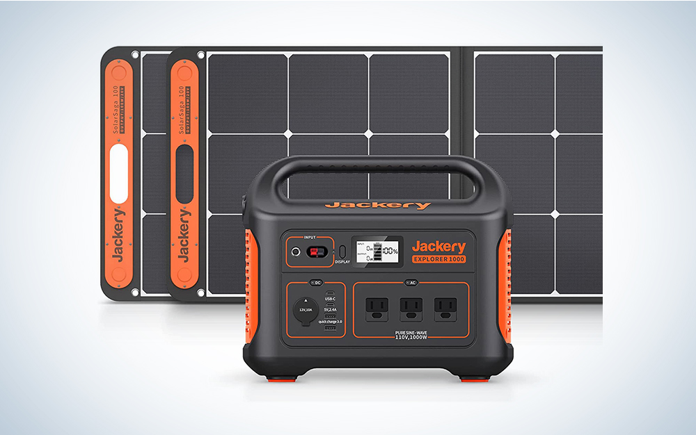A Jackery solar generator with solar panels on a blue and white background