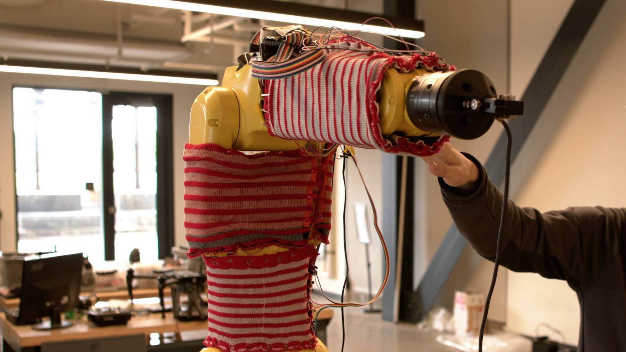 Robot arm encased in smart sweater material