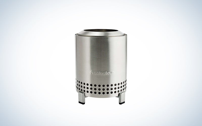 A stainless steel Solo Stove Mesa on a blue and white background