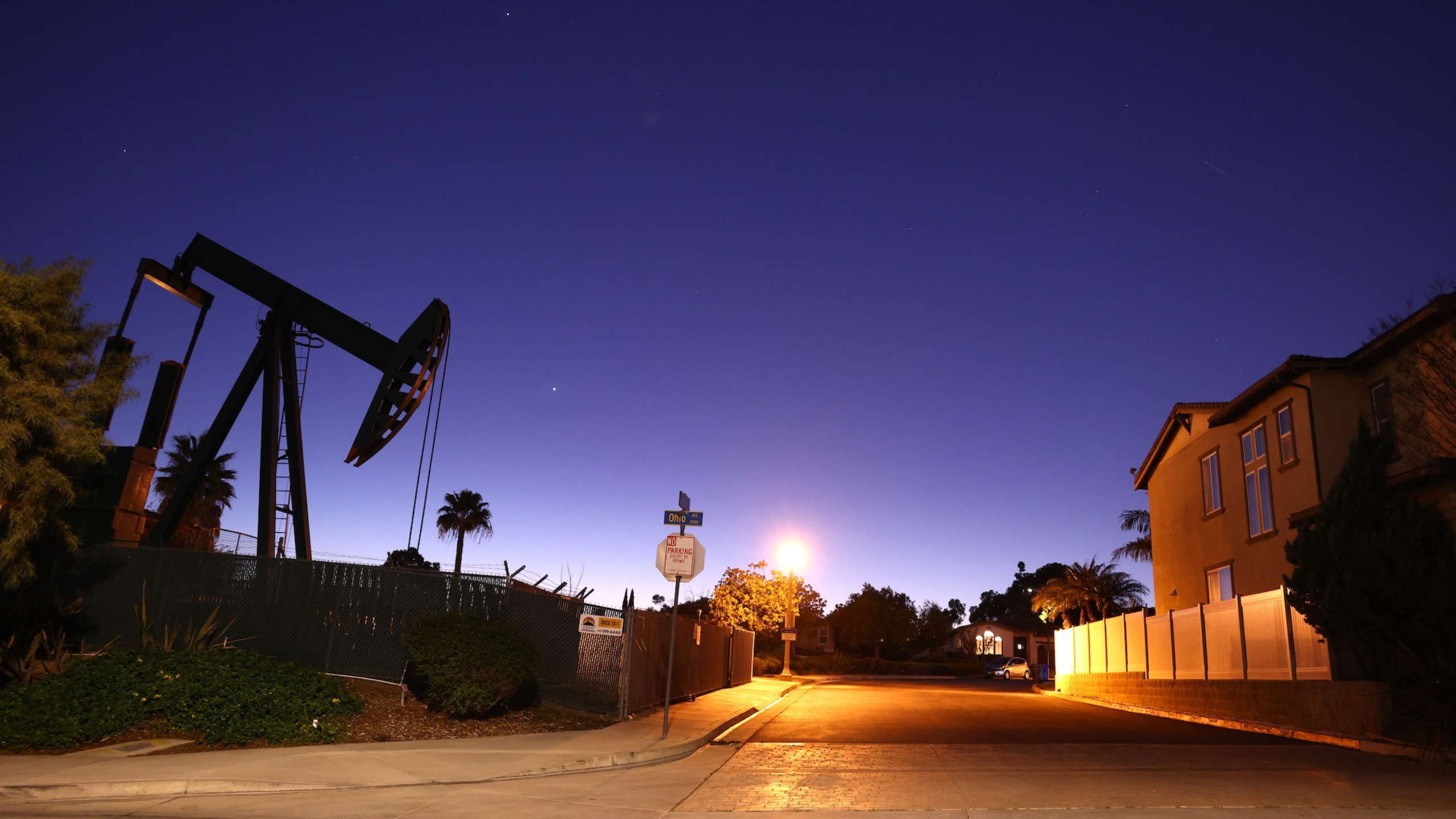 An oil pumpjack stands idle near homes in Signal Hill, California, on Feb. 9.