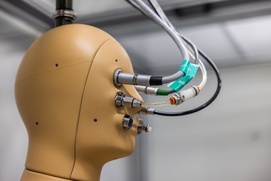ANDI perspiring robot manikin head connected to wiring.