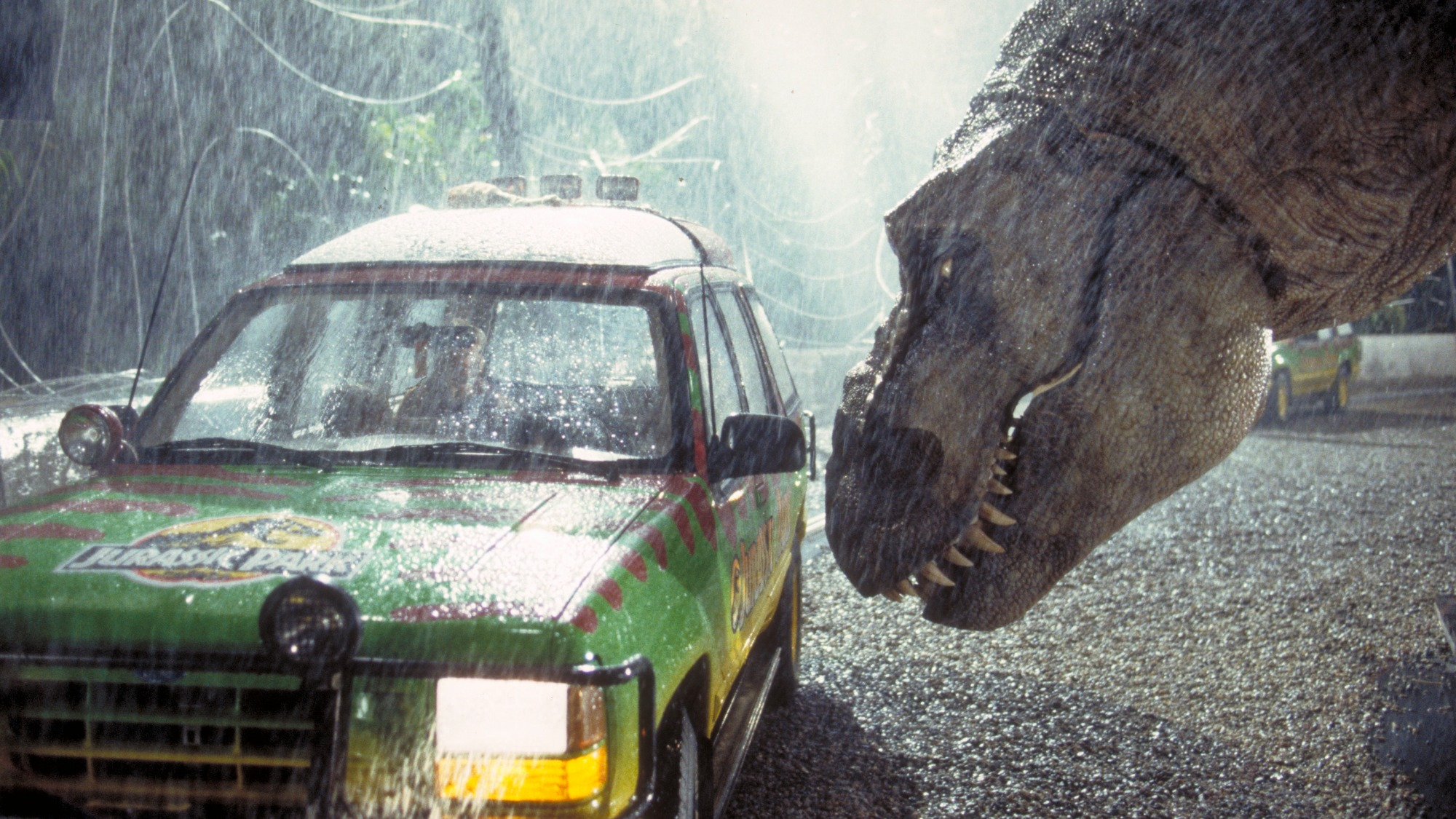 A Tyrannosaurus Rex menaces the theme park's first customers in a scene from the 1993 film Jurassic Park.