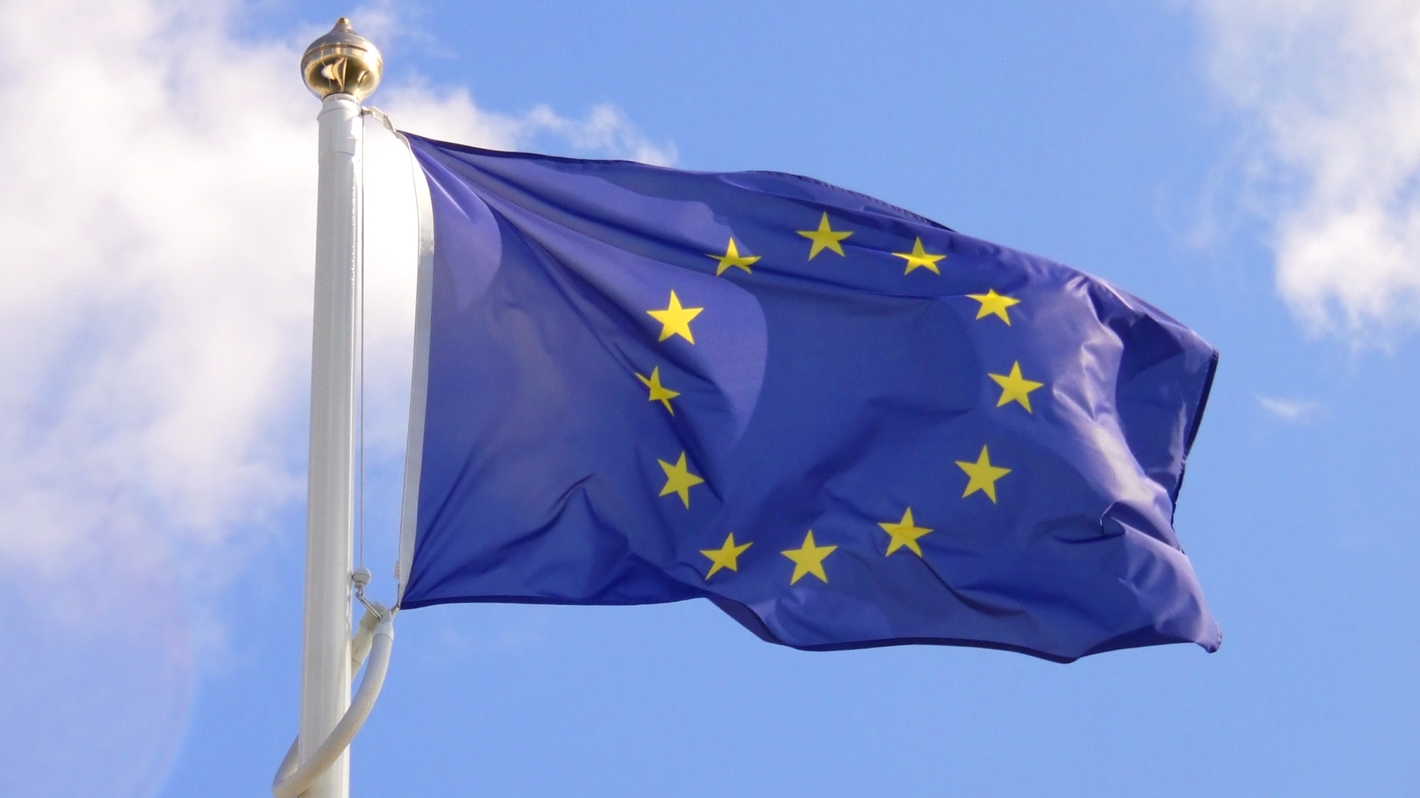 European Union flag waving against blue sky
