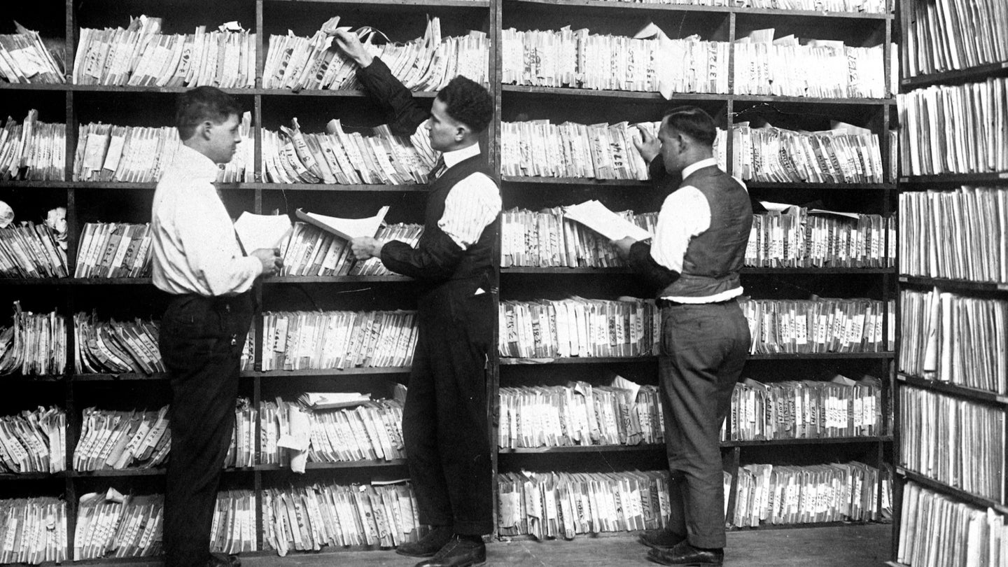 Black and white photo of government workers in a patent filing office