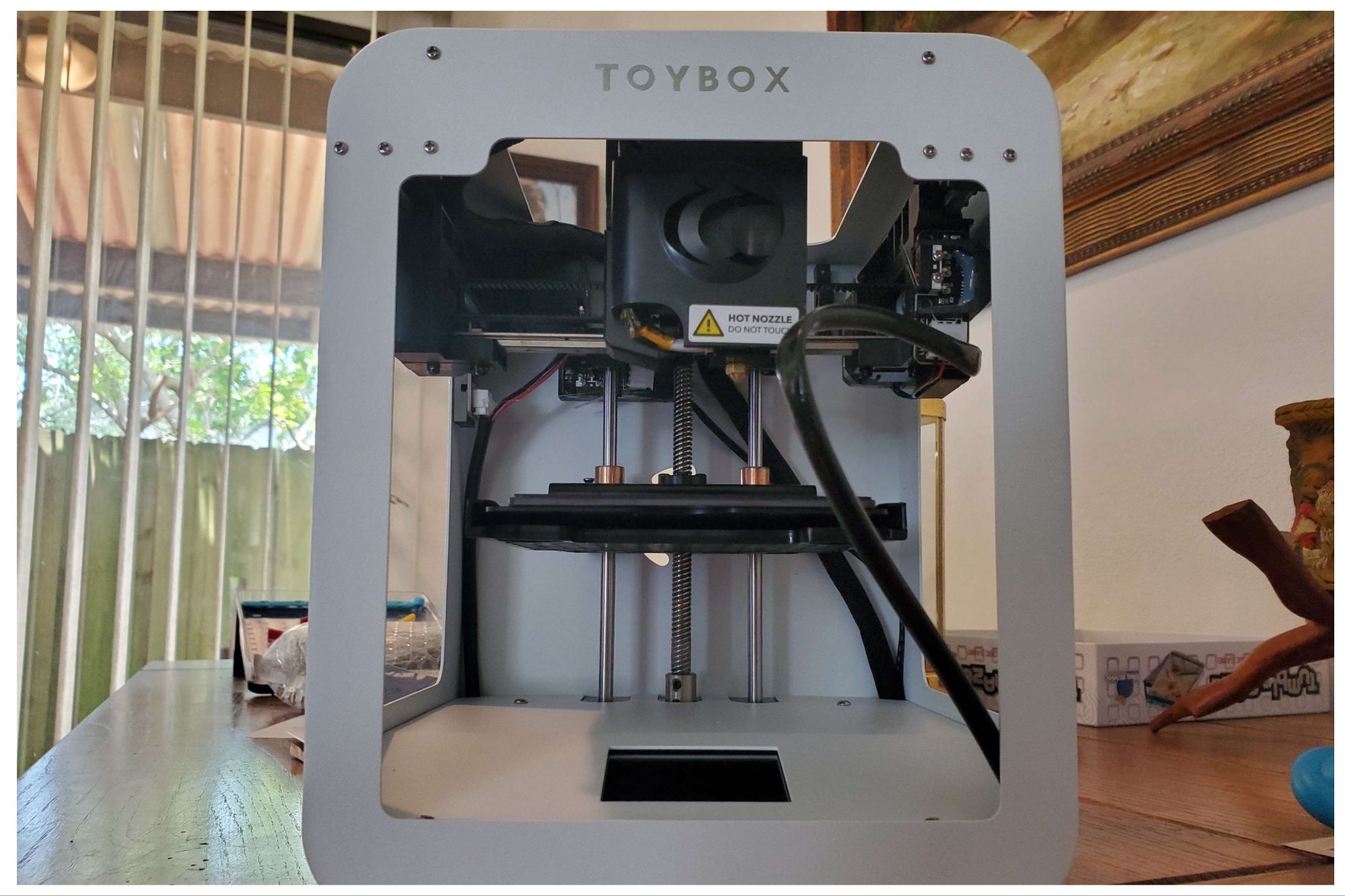 Toybox 3D printer set up on a wooden table.