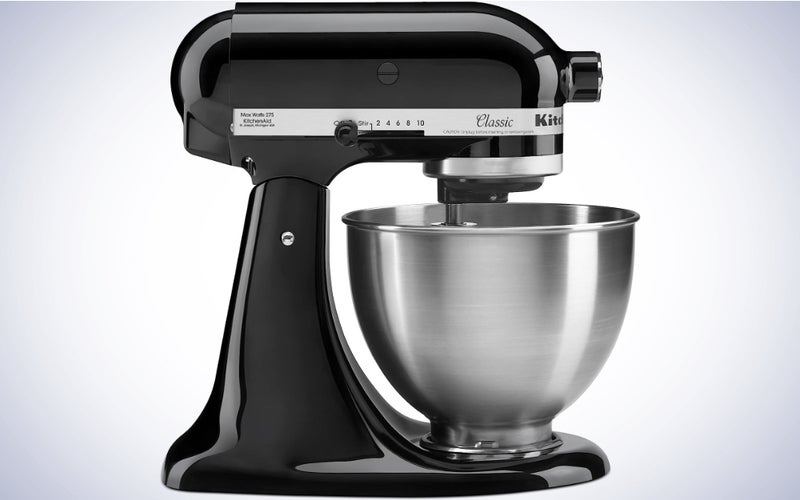 A black KitchenAid stand Mixer on a blue and white gradient background