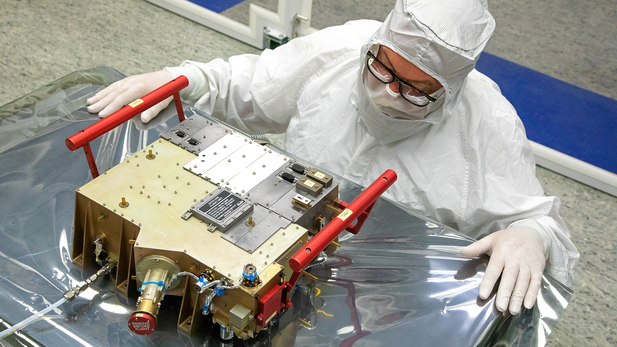 A Southwest Research Institute scientist named Norm Pelletier is wearing all white protective gear as he prepares the Ultraviolet Spectrograph (UVS) for delivery and integration onto the European Space Agency’s JUICE spacecraft. As part of a 10-instrument payload to study Jupiter and its large moons, UVS will measure ultraviolet spectra that scientists will use to study the composition and structure of the atmospheres of these bodies and how they interact with Jupiter’s massive magnetosphere.