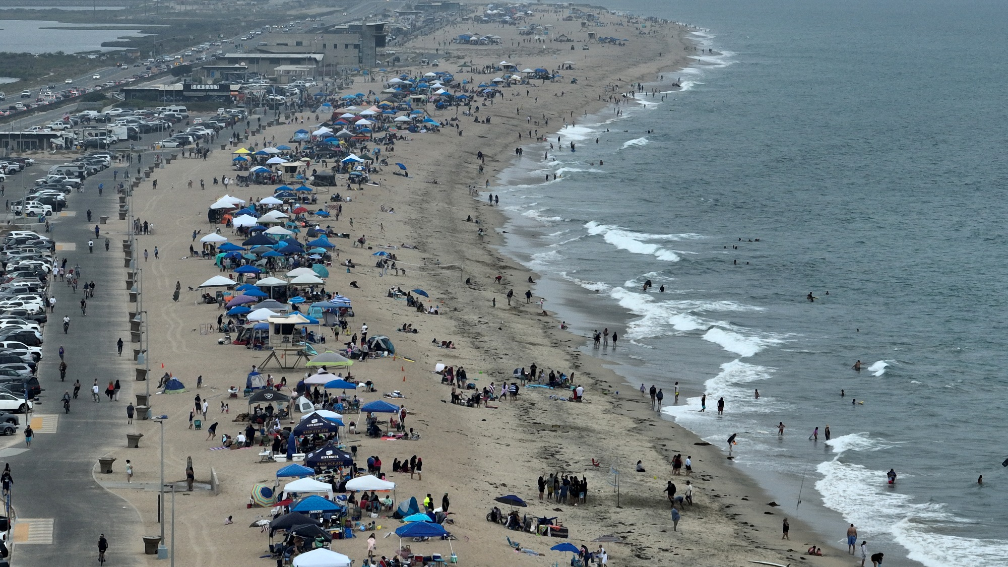 Beach-goers seeking relief from the heat at Bolsa Chica State Beach in Huntington Beach California, on July 1, 2023.