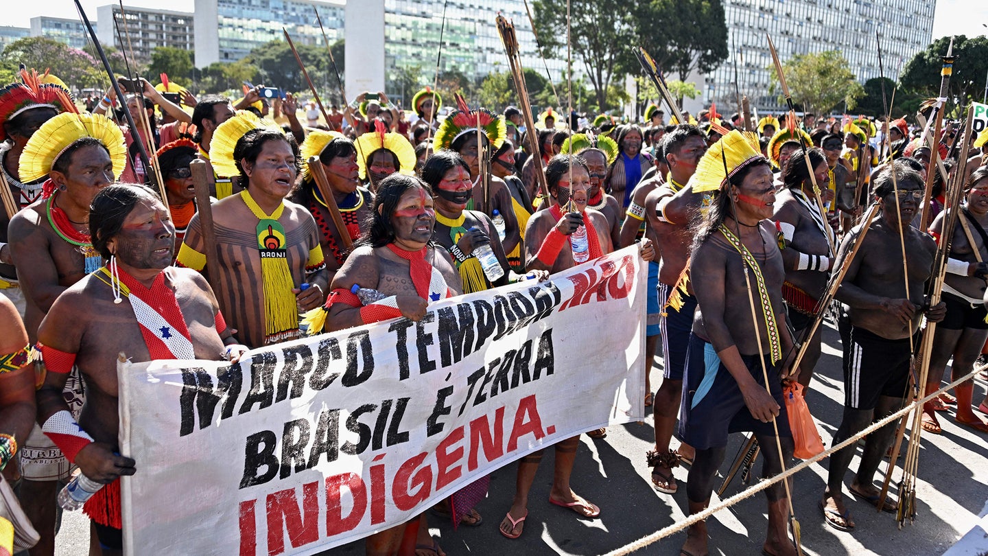 Brazilian Indigenous people from different tribes take part in a demonstration against the so-called legal thesis Marco Temporal (Temporal Milestone), a proposal that could jeopardize the protection of ancestral lands, a day before the country's highest court is due to resume hearing the case, in Brasilia, on June 7, 2023.