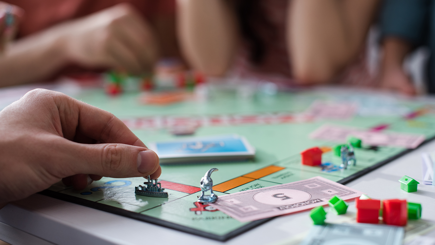 A family plays a board game.