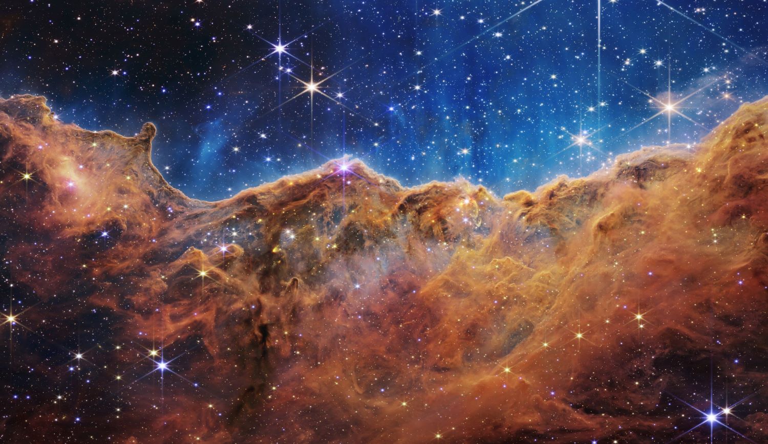 Cliff-like structures are carved into the gas clouds of this nebula.