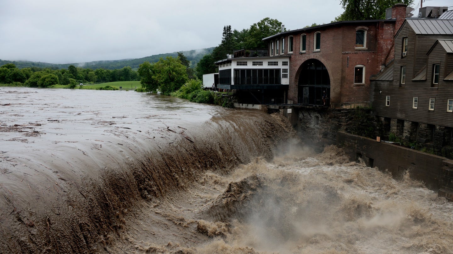 Heavy rain sends mud and debris down the Ottauquechee River in Quechee, Vermont on July 10, 2023.