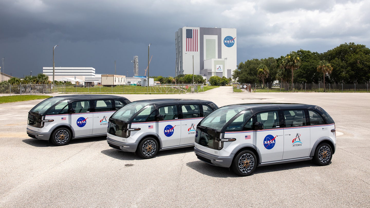 three electric vehicles for nasa parked in a row