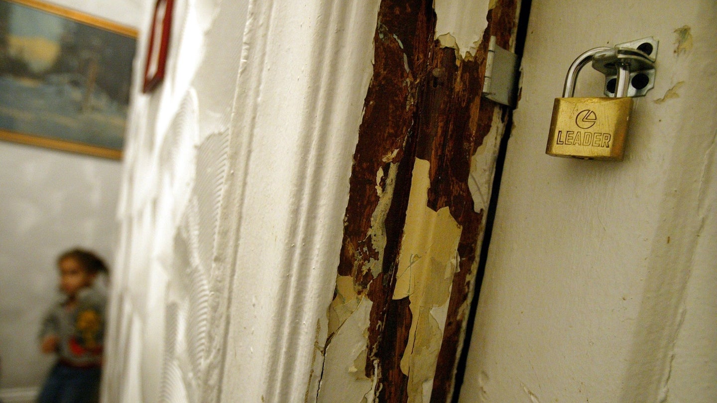 hildren that have high levels of lead in their blood stand next to a peeling lead paint wall in their apartment October 22, 2003 in New York City.