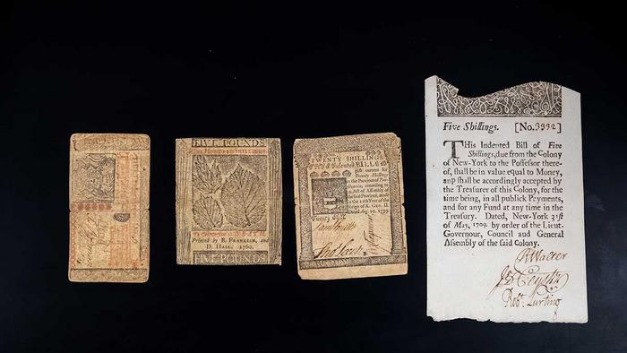 Four examples of colonial paper currency on a black background. Khachatur Manukyan and his team employed cutting-edge spectroscopic and imaging instruments to get a closer look than ever at the inks, paper and fibers that made Benjamin Franklinâs bills distinctive and hard to replicate. 