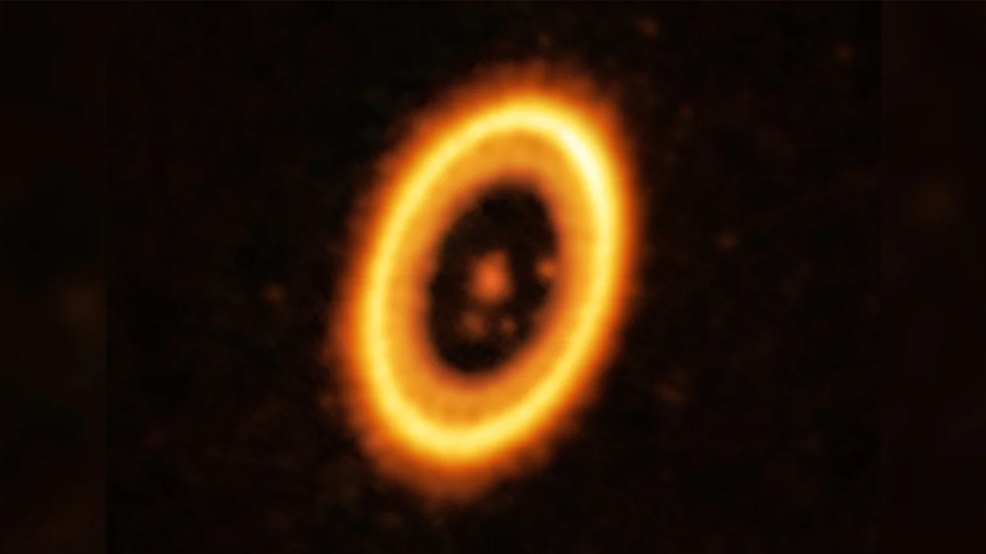 This image taken with the Atacama Large Millimeter/submillimeter Array (ALMA) shows the young planetary system PDS 70, located nearly 400 light-years away from Earth. The system features a star at its center, around which the planet PDS 70 b is orbiting. On the same orbit as PDS 70b, astronomers have detected a cloud of debris that could be the building blocks of a new planet or the remnants of one already formed. The ring-like structure that dominates the image is a circumstellar disc of material, out of which planets are forming. There is in fact another planet in this system: PDS 70c, seen to the right of the inner rim of the disc.