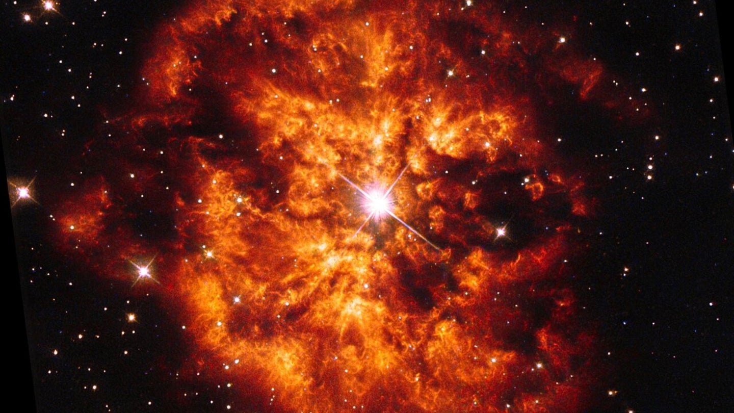 Orange, fire-like clouds extend from a central star.