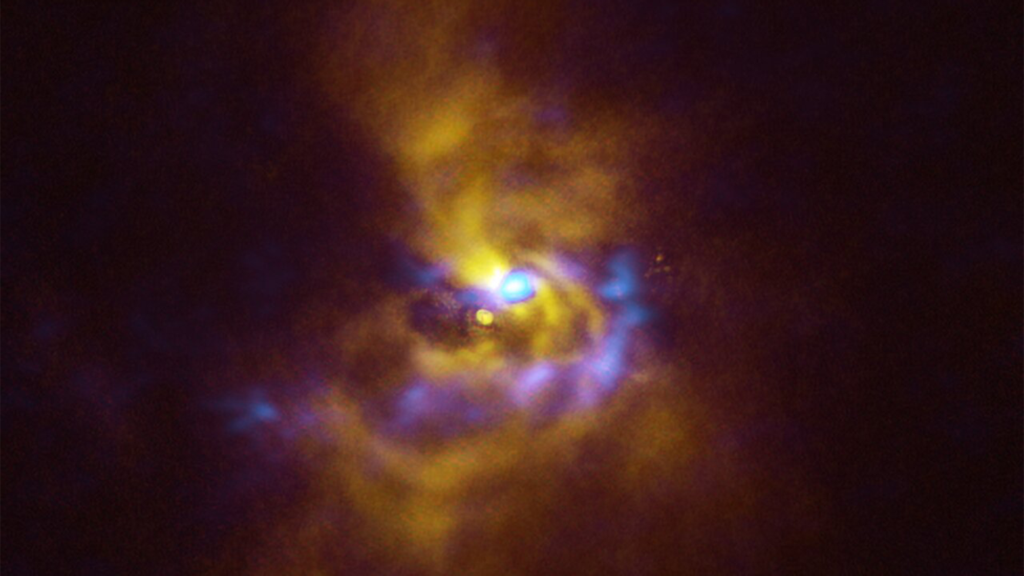 A young star named V960 Mon is at the center, with dusty material with the potential to form planets surrounding it. V960 Mon is located over 5000 light-years away from Earth in the constellation Monoceros.