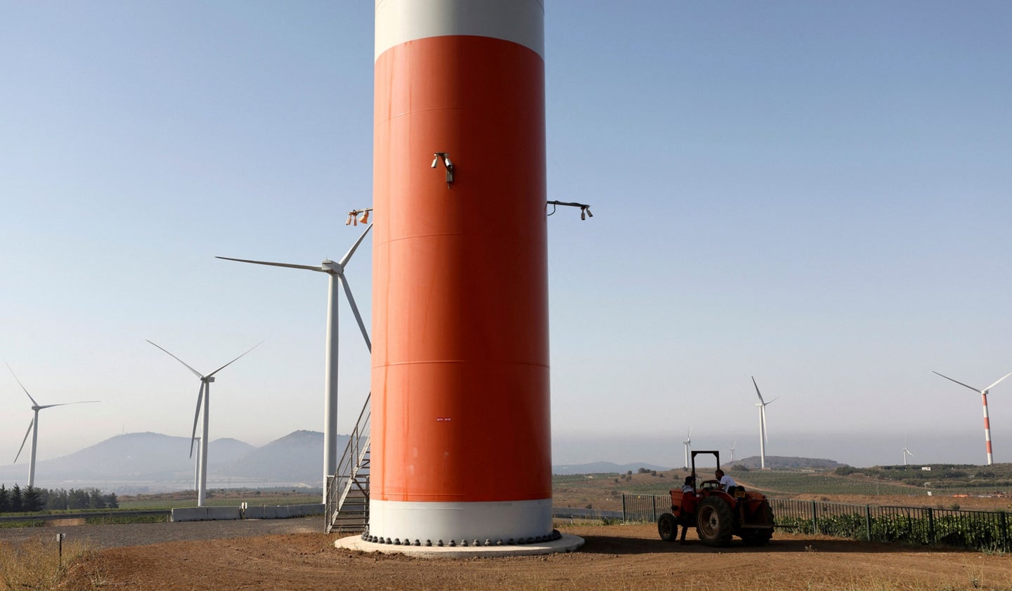 Wind turbine with red base in the Golan Heights between Syria and Israel