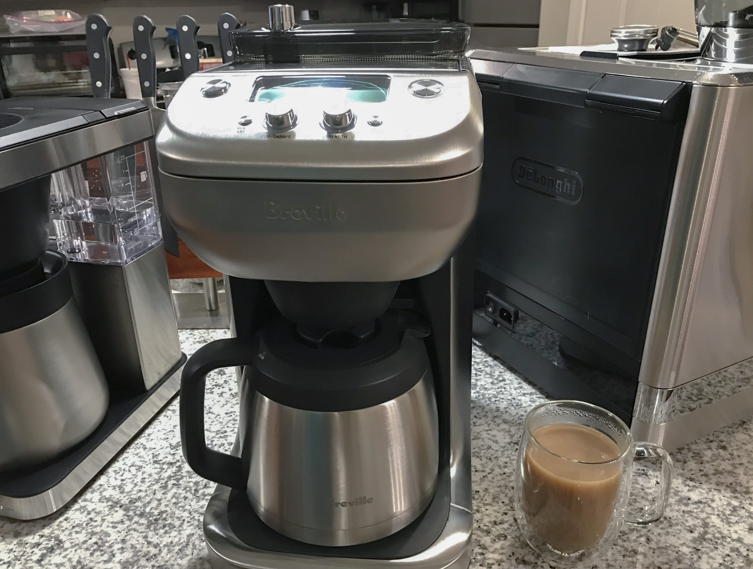 Breville Grind Control best with grinder chrome drip coffee maker on a crowded kitchen counter