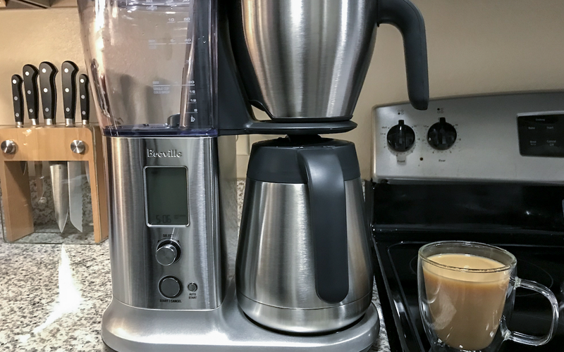 Breville Precision Brewer best overall drip coffeemaker with chrome thermal carafe on a crowded kitchen counter
