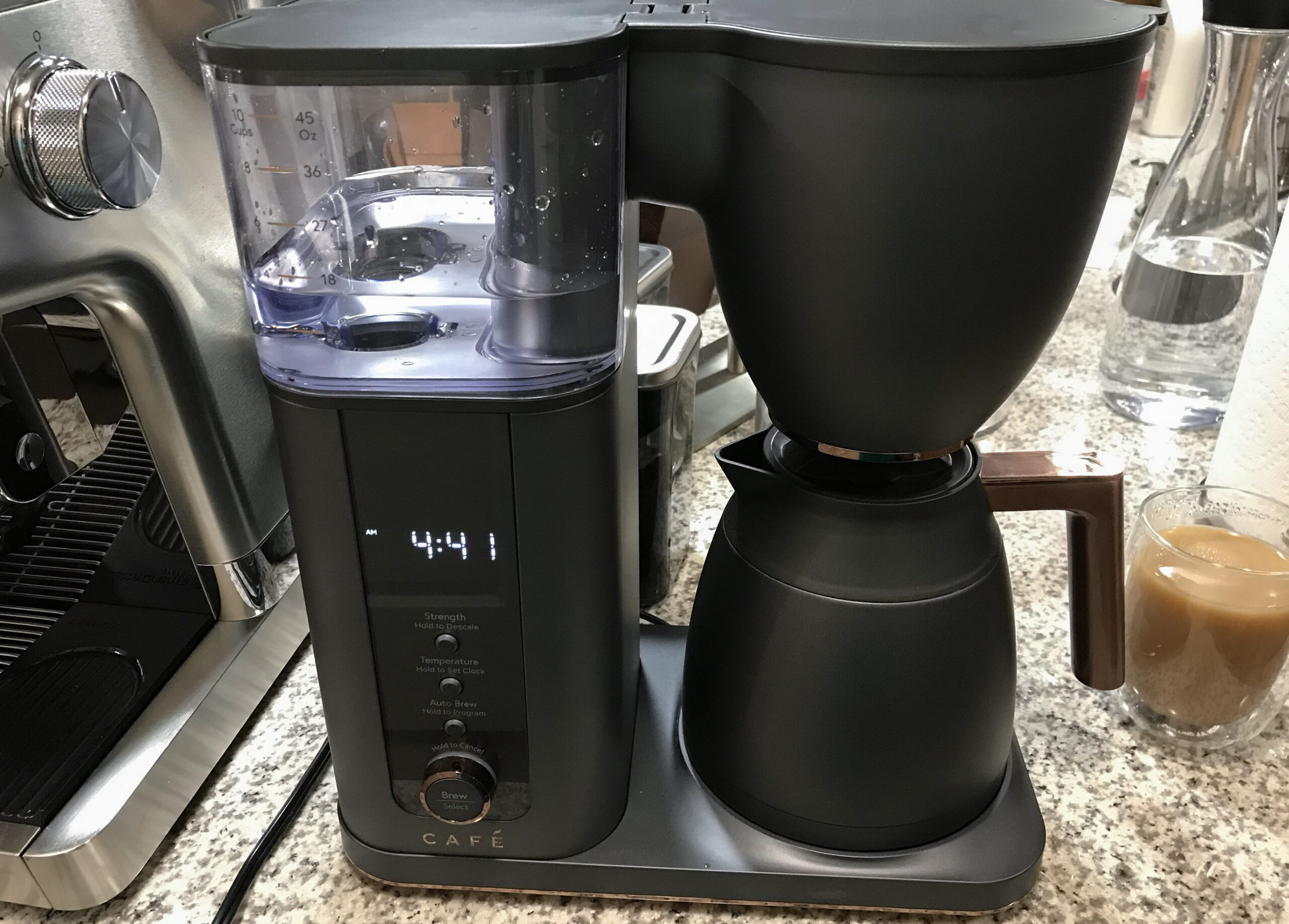 Cafe Specialty best smart drip coffee maker with a black carafe on a crowded kitchen counter