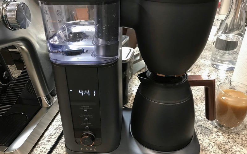 Cafe Specialty best smart drip coffee maker with a black carafe on a crowded kitchen counter