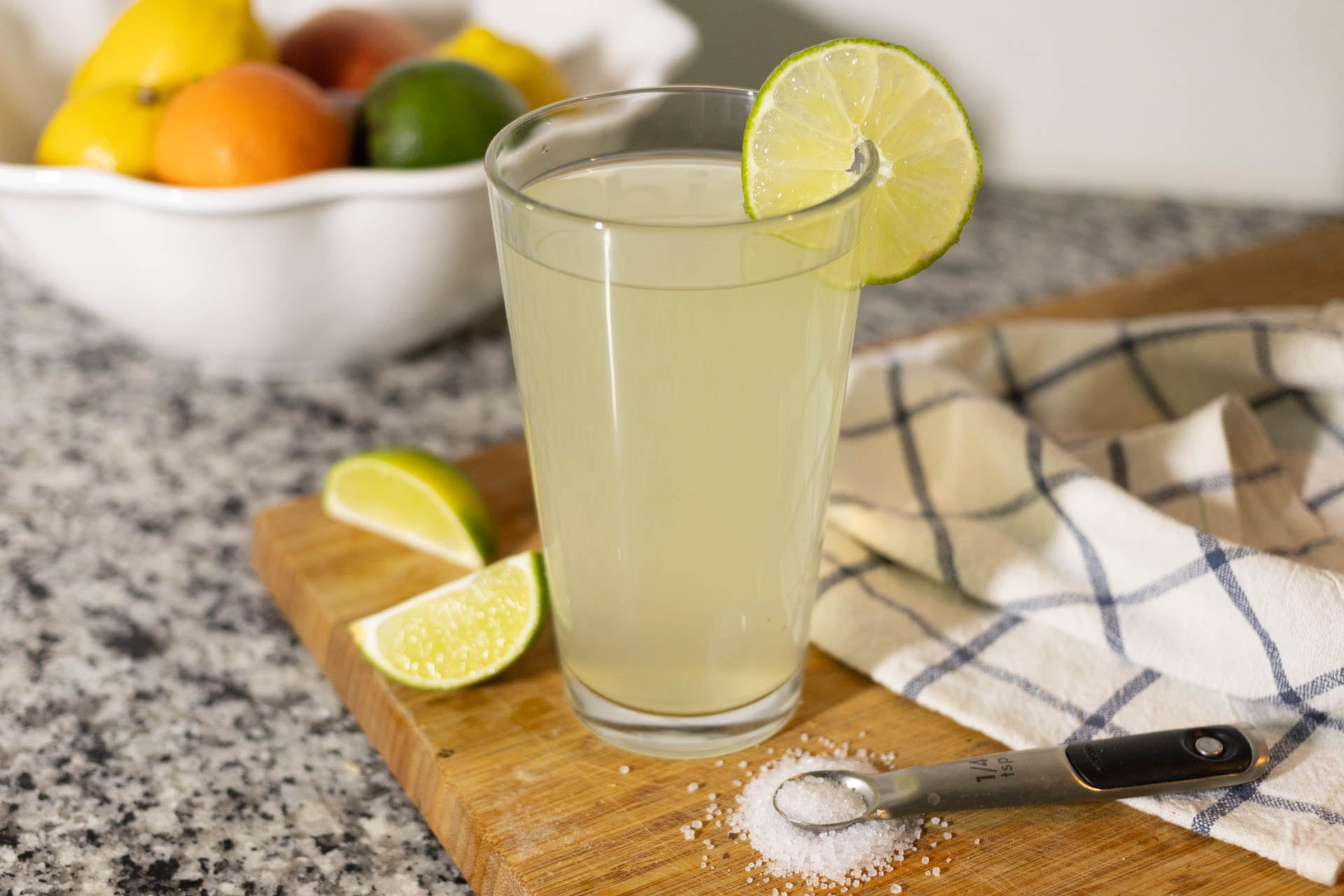 A glass of DIY electrolyte drink with lemons and salt.