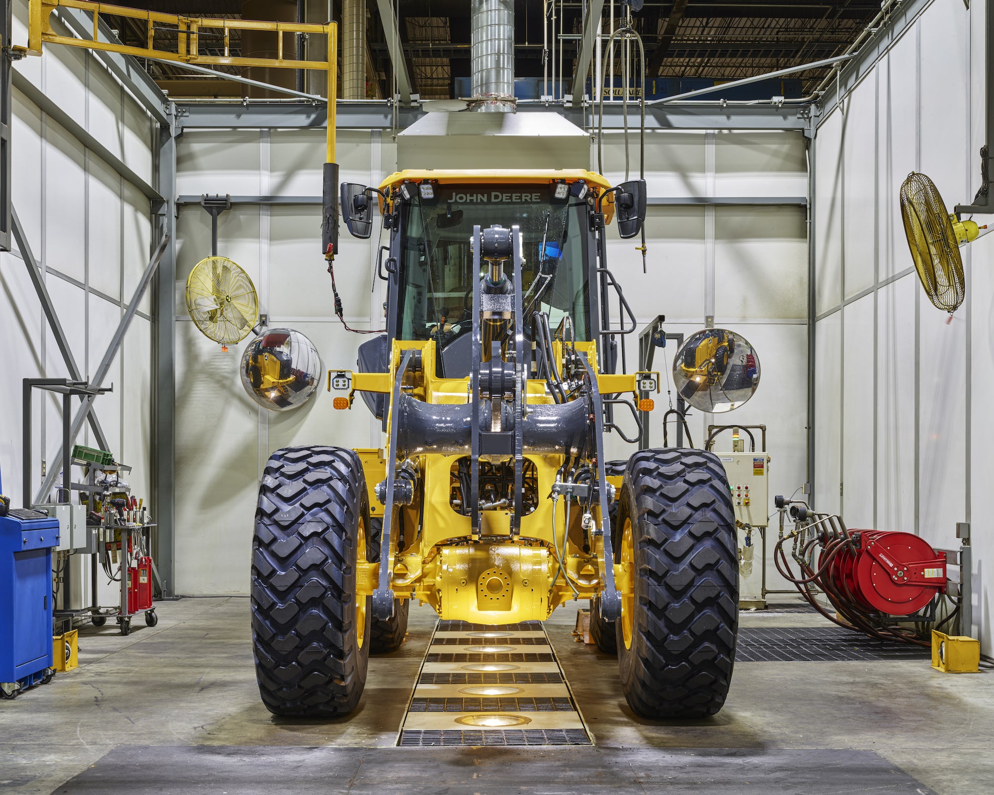 a john deere wheel loader without a front bucket in a factory