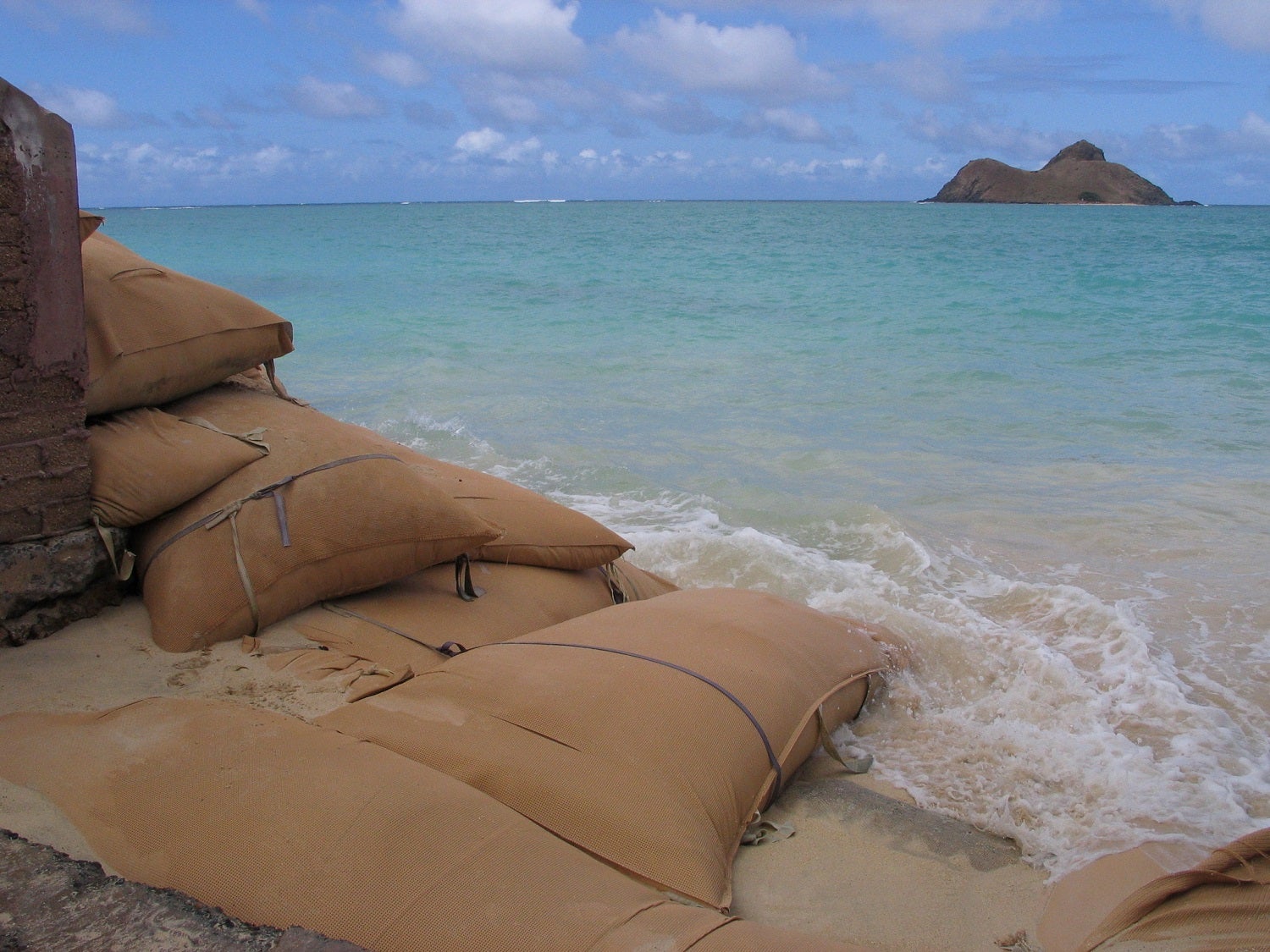 Sandbags on Lanikai Beach on Oahu, Hawaii to prevent coastal erosion