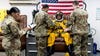 a U-2 pilot sits in a chair with his pressure suit and helmet on