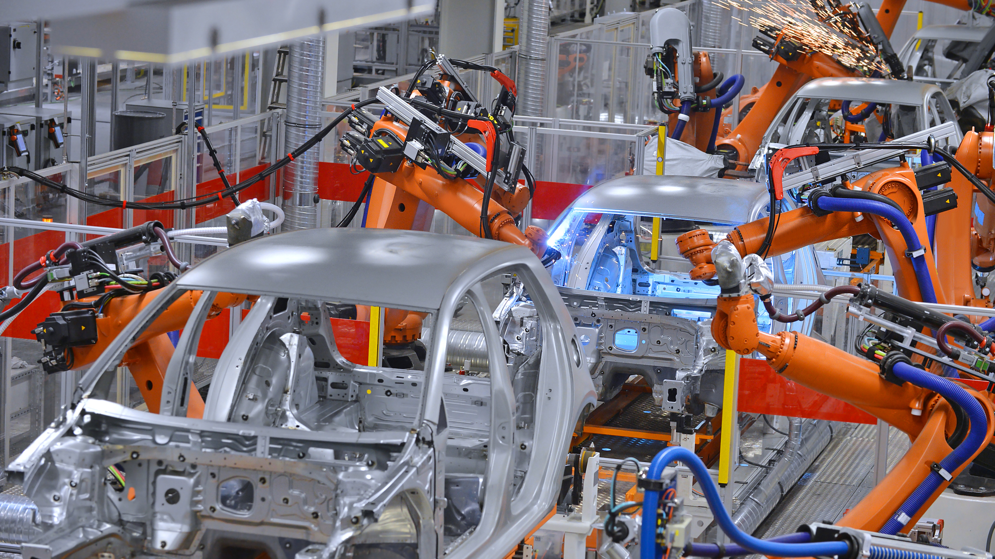 Robotic arms welding car frames on automotive assembling line