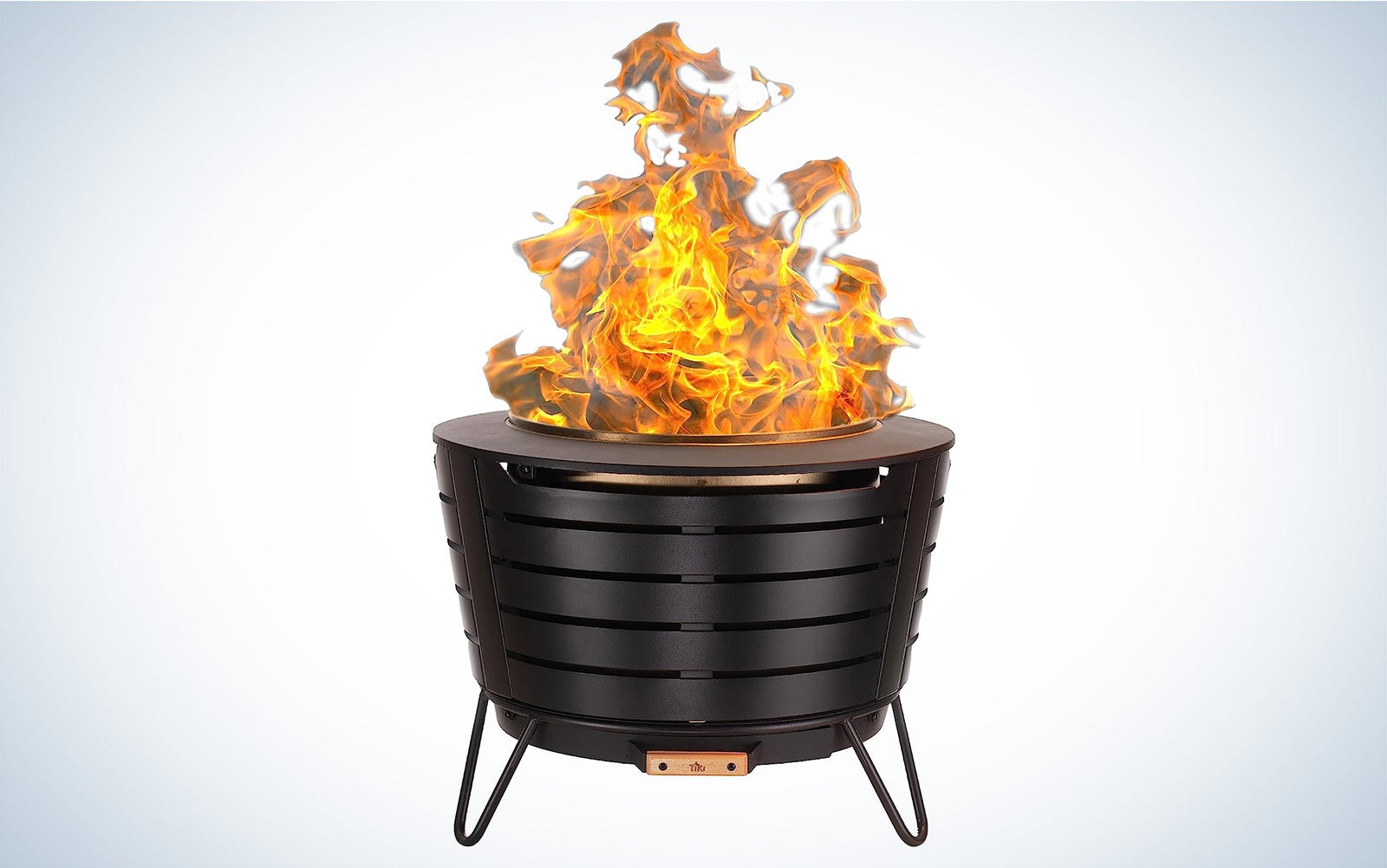 Tiki smokeless fire pit with a fire going in it