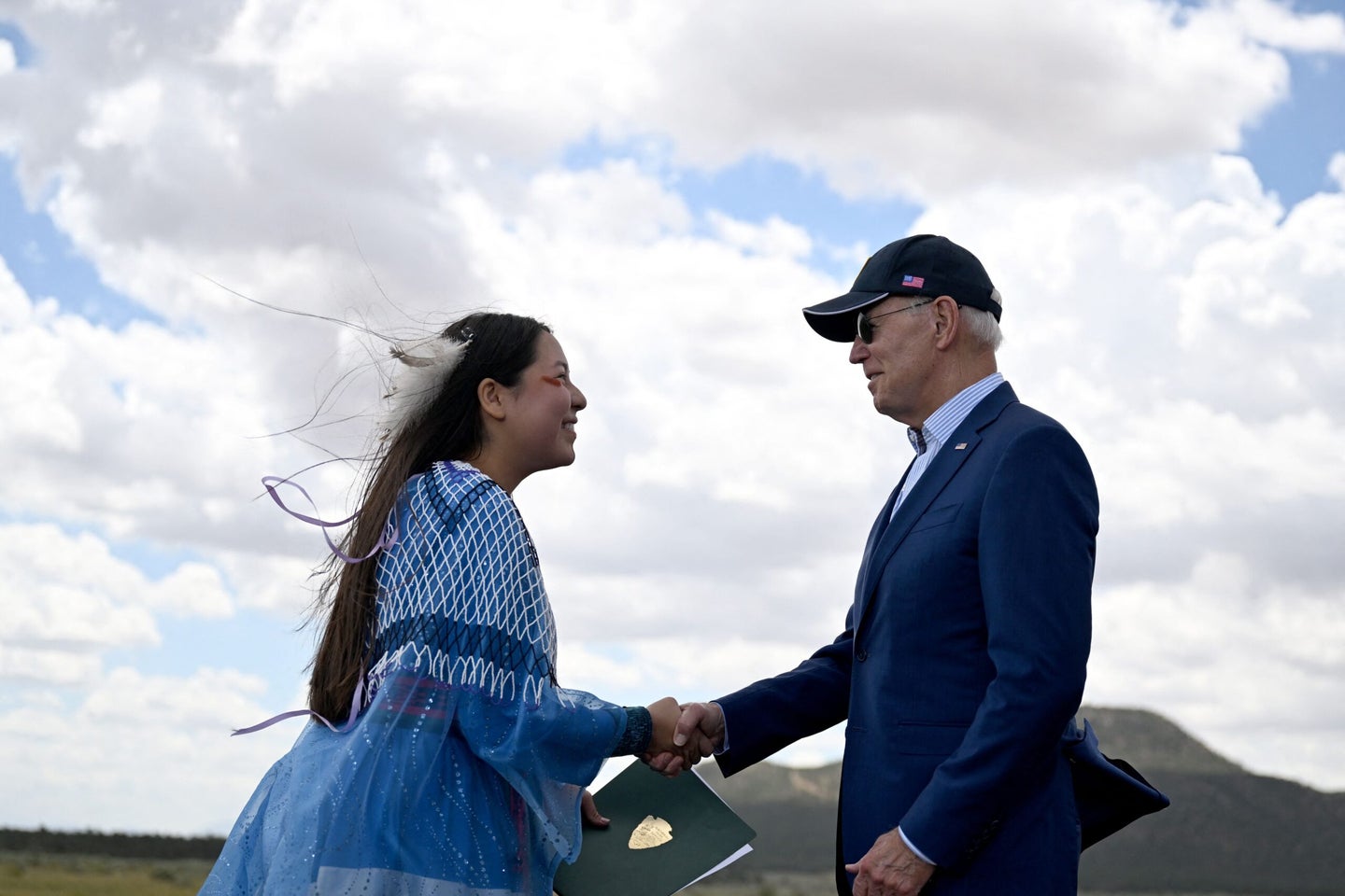 Maya Tilousi, member of the Hopi Tribe, Havasupai Tribe of Grand Canyon, and the Cheyanne and Arapaho Tribes, shakes hands with President Joe Biden at Red Butte Airfield, 25 miles south of Tusayan, Arizona, on August 8, 2023. Biden announced he is putting the brakes on uranium mining around the Grand Canyon and willl give an area of nearly one million acres national monument status.