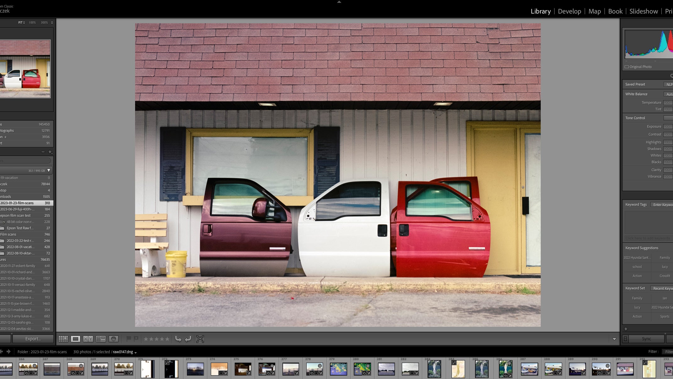 Lightroom classic with a picture of car doors leaning against a building in the edit window